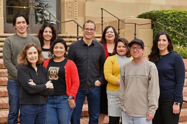Staff of the Chicano Studies Research Center pose in front of Haines Hall